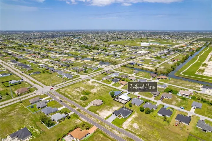 Aerial view of property's location with nearby suburban area and a large body of water