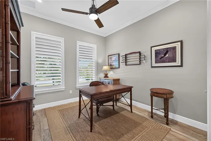 Light gray wall paint complemented by crown molding and white baseboards