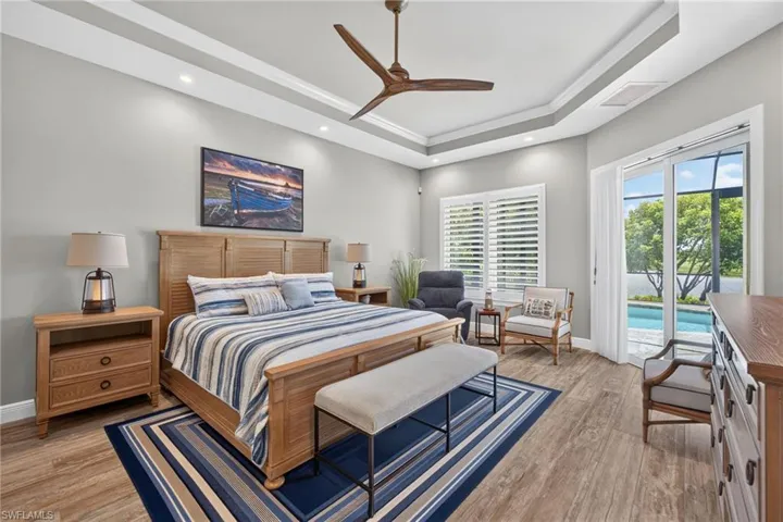 Primary Bedroom tray ceiling with recessed lighting and a ceiling fan