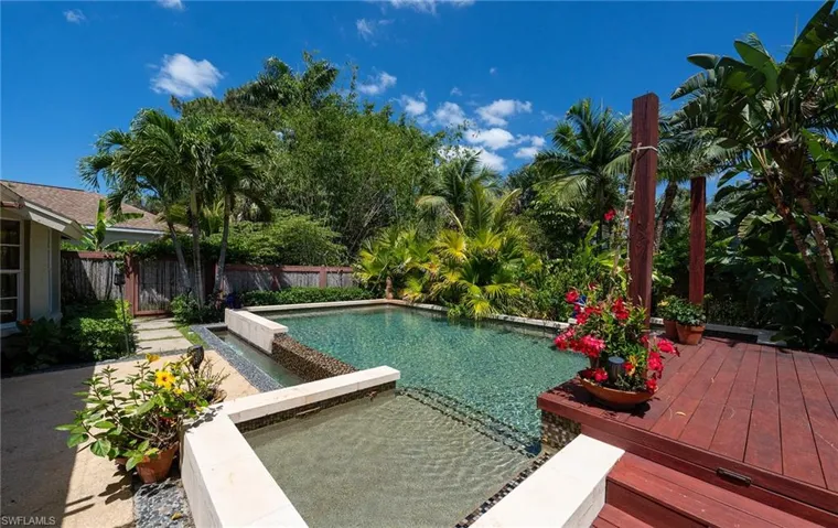 View of pool featuring a wooden deck