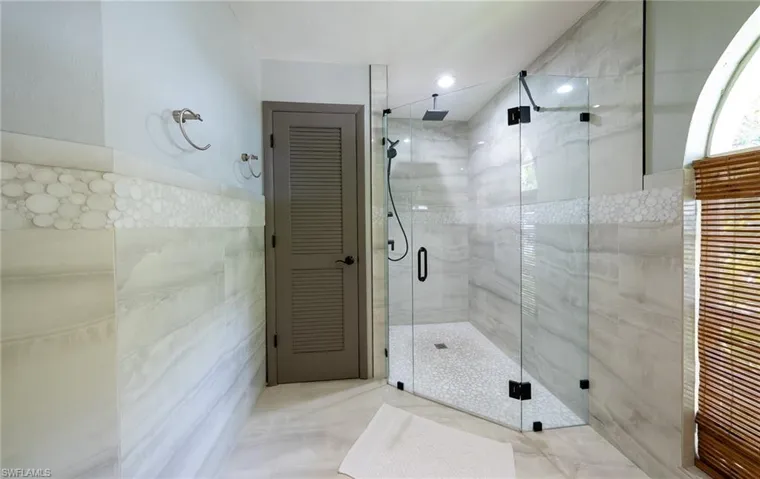 Full bathroom with tile walls and a stall shower