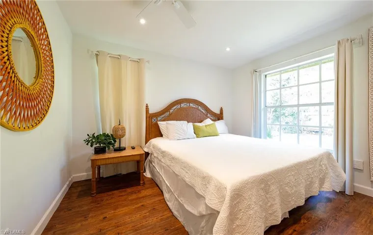 Bedroom with dark wood finished floors, baseboards, a ceiling fan, and recessed lighting