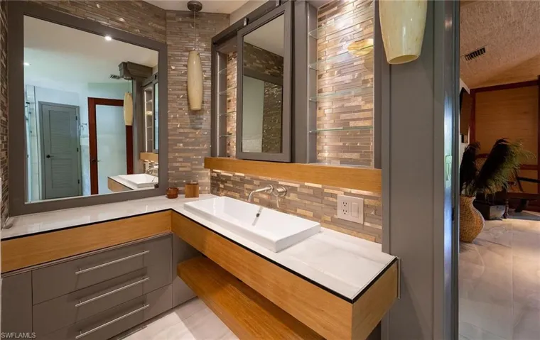 Bathroom with tasteful backsplash and vanity