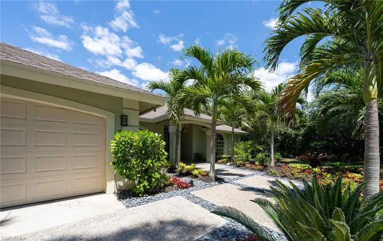 Doorway to property featuring stucco siding and a garage