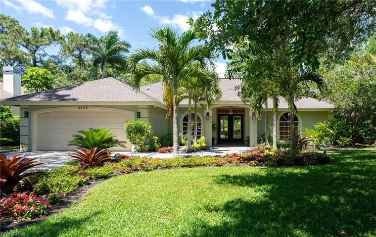 Single story home featuring french doors, a garage, a front yard, stucco siding, and a shingled roof
