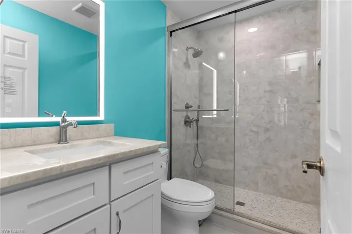 Bathroom featuring vanity and a stall shower