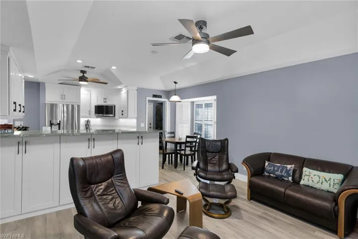 Living area featuring recessed lighting, light wood-type flooring, and a ceiling fan