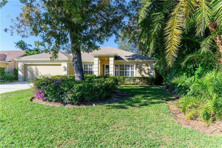 Ranch-style home featuring stucco siding, concrete driveway, an attached garage, and a front yard