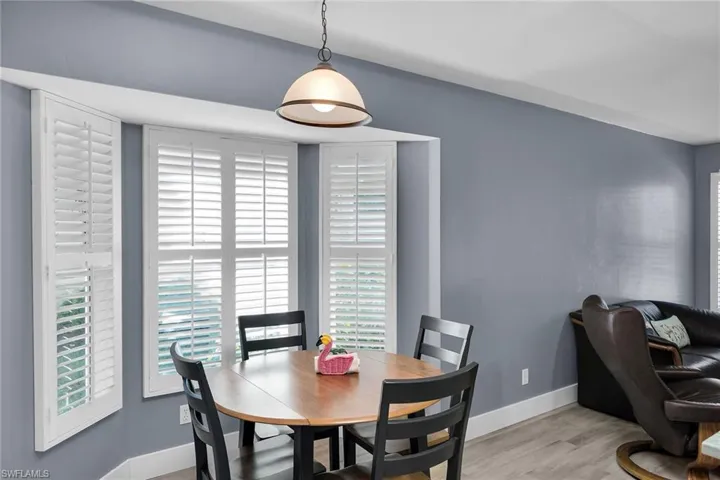 Dining space featuring baseboards and wood finished floors