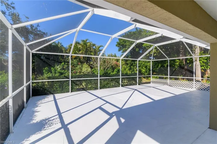 View of patio with glass enclosure and a sunroom