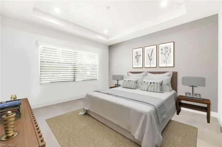 Virtually staged Primary Bedroom featuring a tray ceiling, recessed lighting, and light tile patterned floors