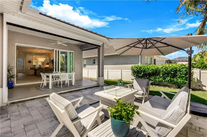 View of lanai featuring outdoor lounge area with gas fire pit.