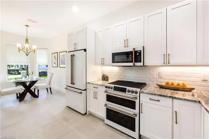 Kitchen featuring high quality appliances with a light and bright breakfast nook.