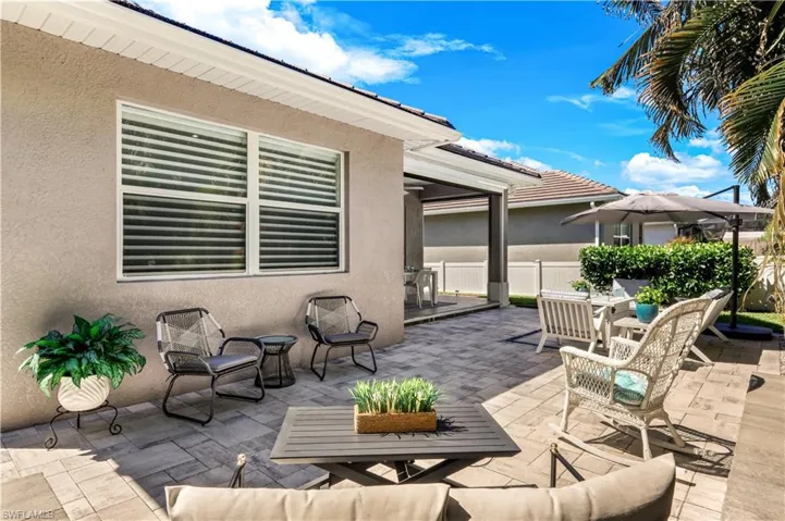 View of lanai with outdoor lounge area and dining space.