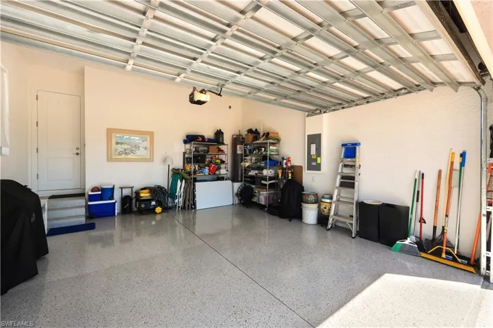 Epoxy floor garage with ceiling extra storage racks.