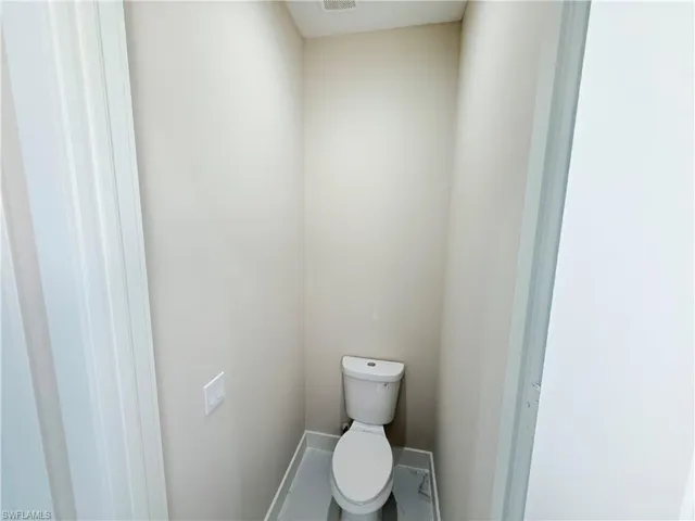 Bathroom featuring toilet and baseboards