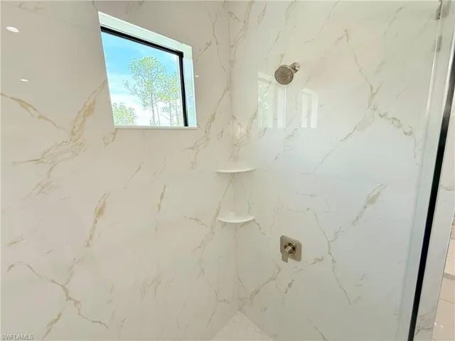 Bathroom view of a marble finish shower