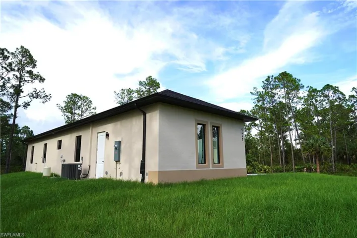 View of side of home with stucco siding and a central air condition unit