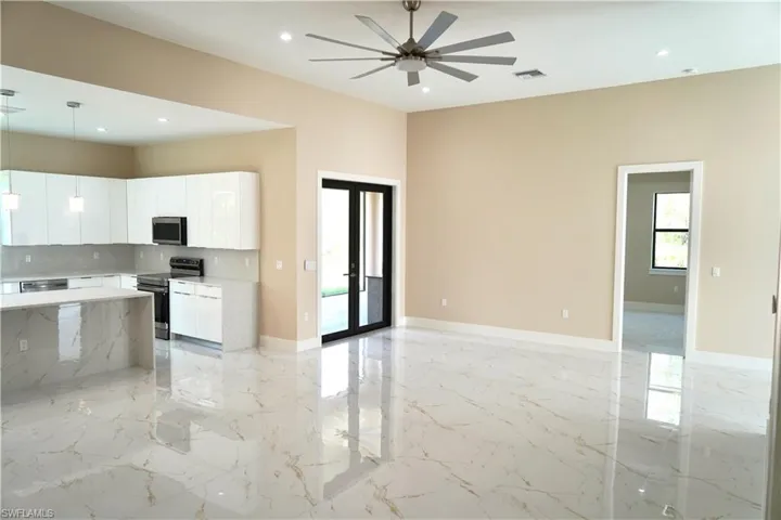 Kitchen with pendant lighting, light marble finish floors, open floor plan, stainless steel appliances, and recessed lighting