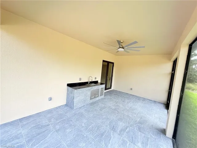 View of patio with ceiling fan and exterior kitchen
