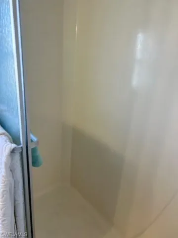 Full bathroom featuring a shower stall