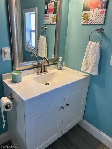 Bathroom featuring vanity and grey wood-style floors