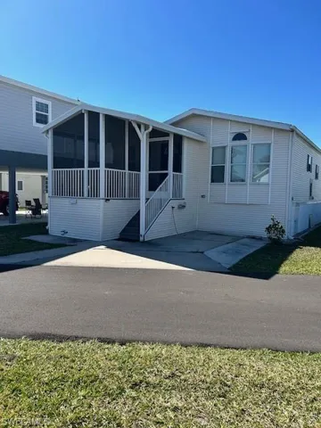 Manufactured / mobile home featuring a patio and a sunroom