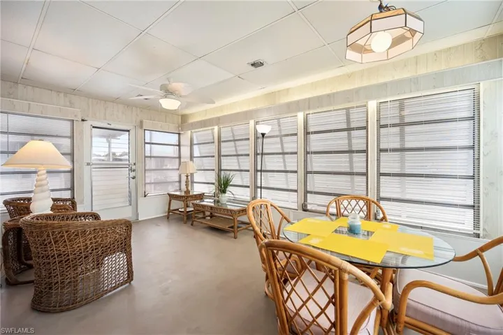Sunroom / solarium with concrete flooring and a paneled ceiling