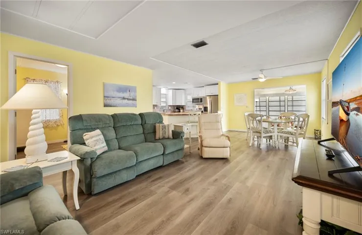 Living room featuring light wood-style flooring and ceiling fan