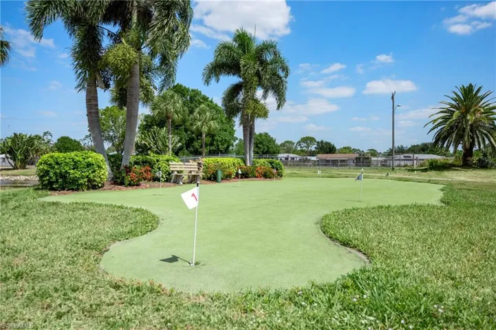 View of property's community with a putting area