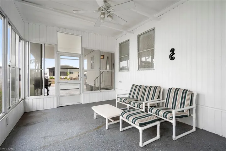 Sunroom featuring ceiling fan