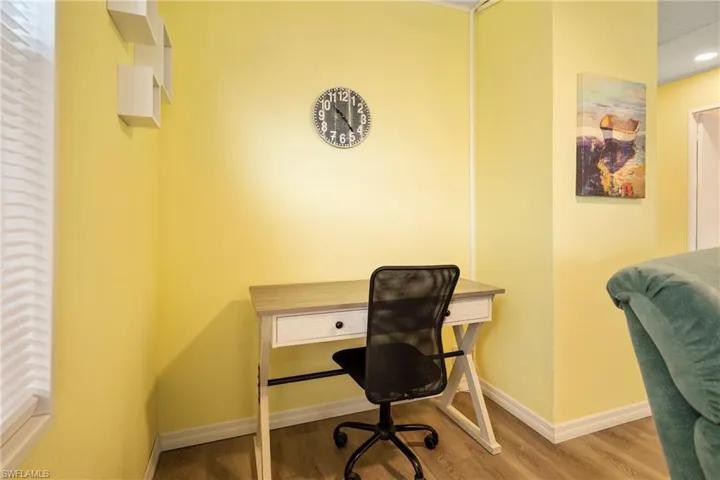 Home office featuring wood finished floors and baseboards