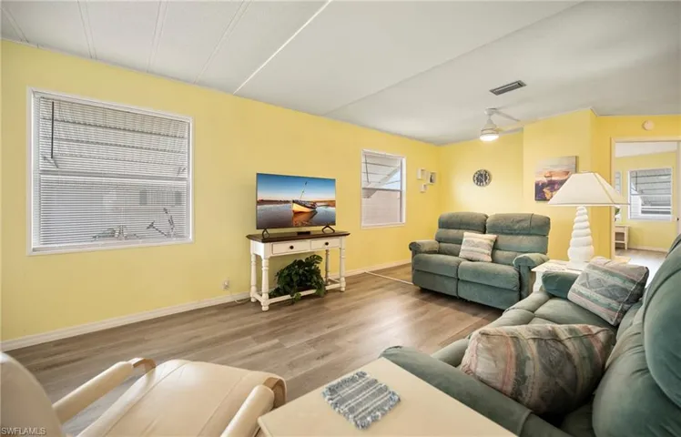 Living area featuring wood finished floors and ceiling fan