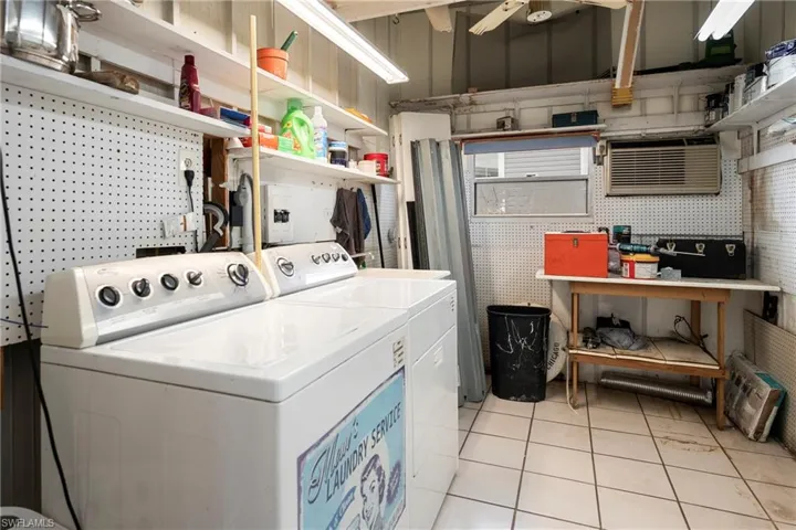 Laundry area featuring washer and dryer and light tile patterned floors