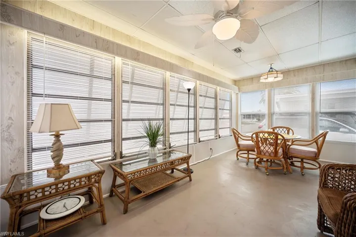 Sunroom / solarium featuring finished concrete flooring and baseboards