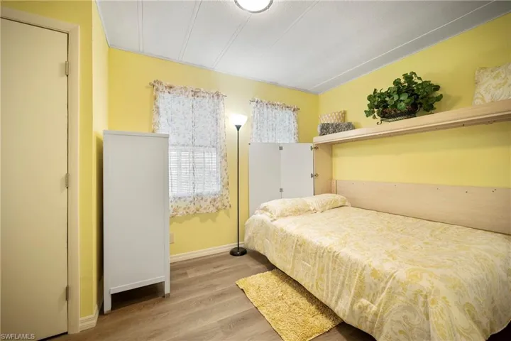 Bedroom featuring light wood-style floors and baseboards