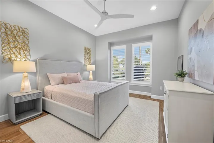 Spacious room featuring wood-finish flooring, recessed lighting, and a contemporary ceiling fan