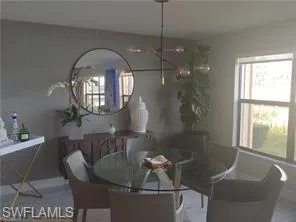 Dining area with a chandelier and baseboards