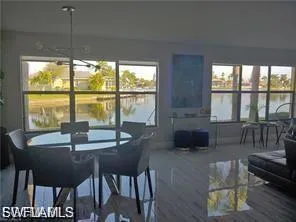 Dining area featuring a chandelier and a water view