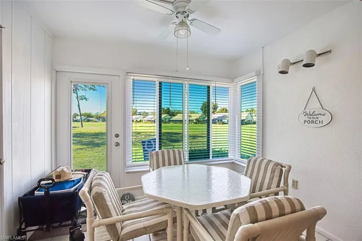 Dining space featuring a ceiling fan and a textured wall