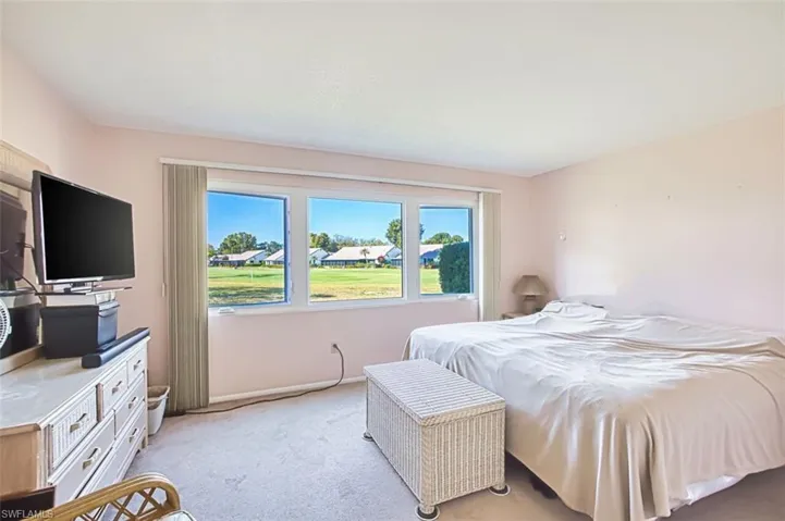 Bedroom with carpet and a residential view