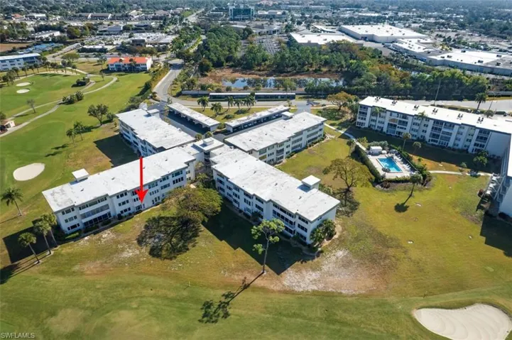View of property location with a local golf course and apartment complex / building