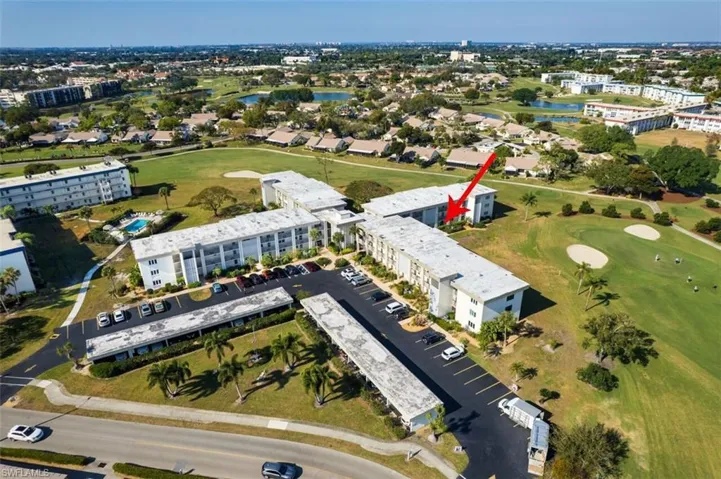 Aerial view of property's location with a local golf course and a nearby body of water