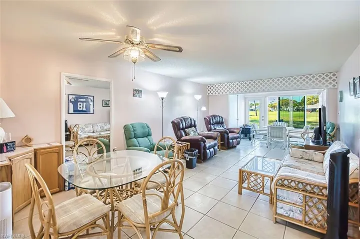 Dining room featuring light tile patterned floors and ceiling fan