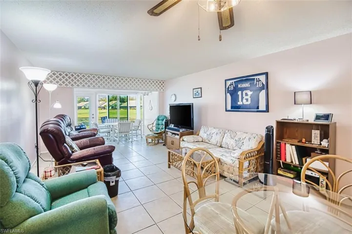 Living room featuring tile patterned flooring and ceiling fan