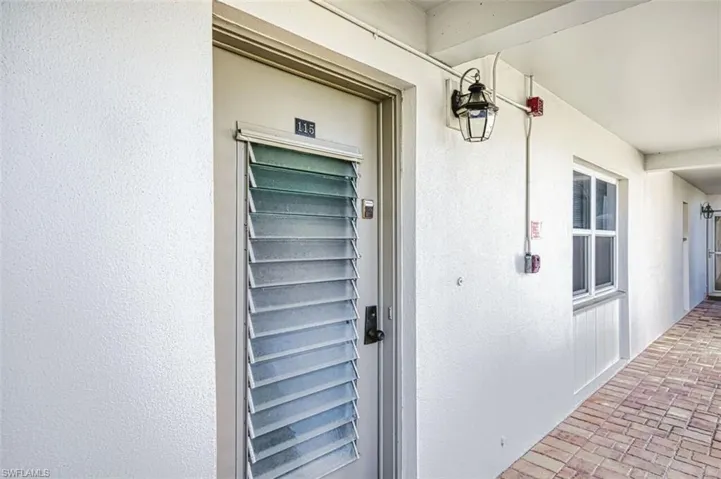 View of exterior entry with stucco siding