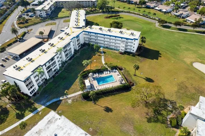 Aerial view of apartment complex / building and a golf course