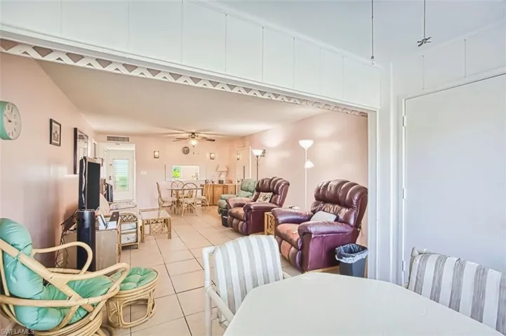 Dining space featuring light tile patterned floors and ceiling fan