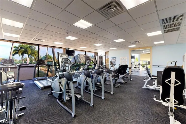 Exercise room with a paneled ceiling and floor to ceiling windows
