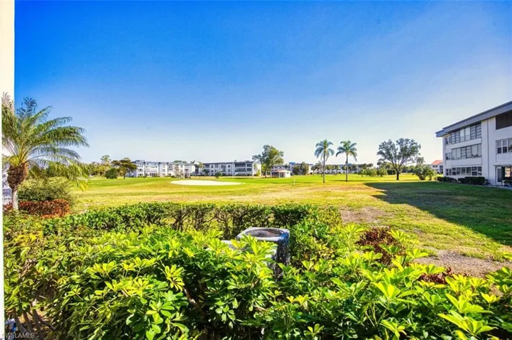 View of green lawn featuring golf course view